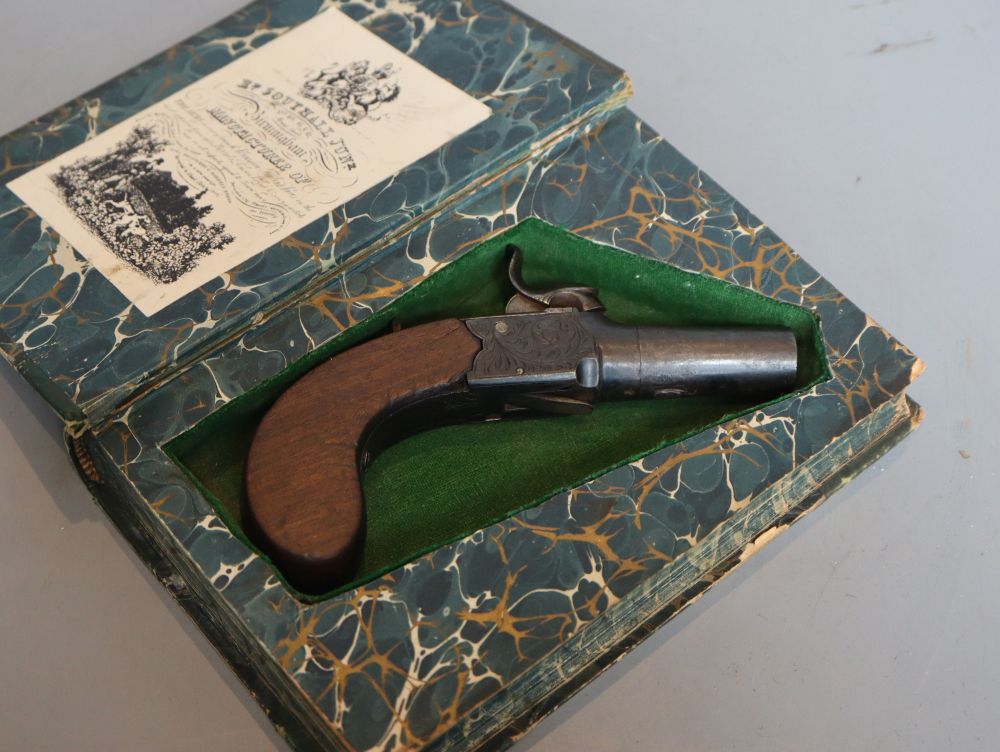 A 19th century boxlock percussion pistol concealed in a copy of Forty Five Guardsmen